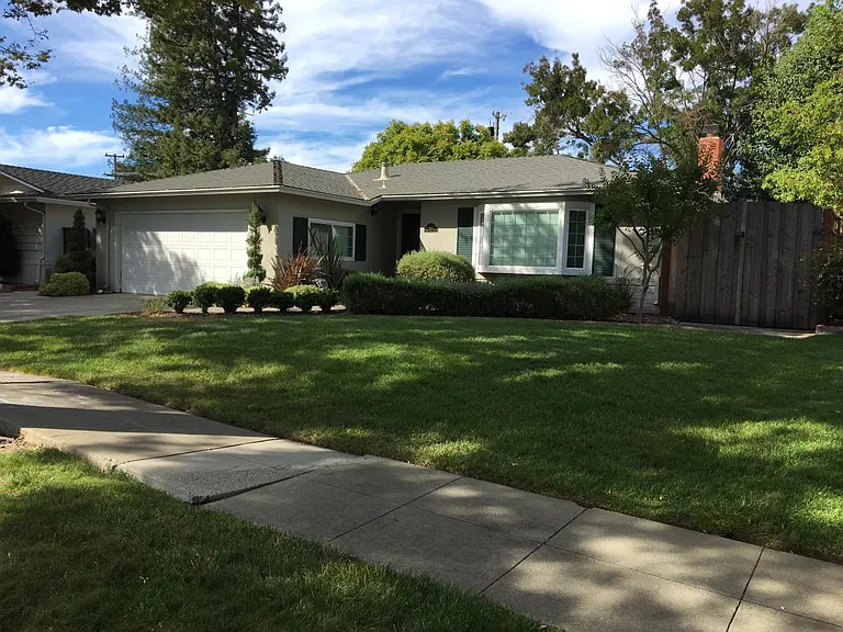 Front of the house, shed is behind the gate.