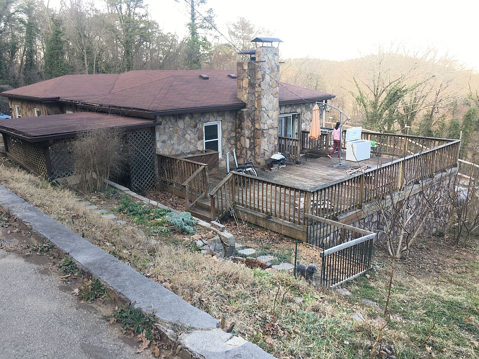 View of house from the road. House has look out mountain conservancy land to the left and private forest to the right. Neighbors are high up hill. House has a very private setting with LARGE yard all around it yet still in St. Elmo.