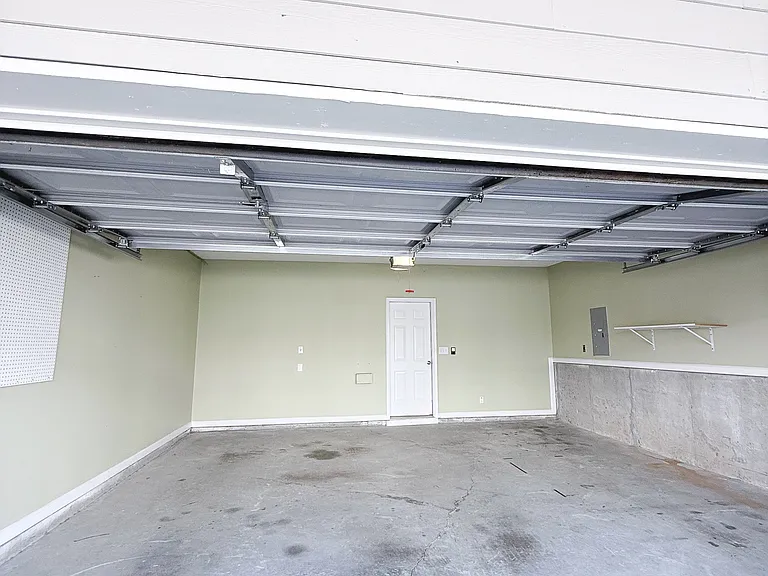 Garage entrance and deck off of quiet alleyway.