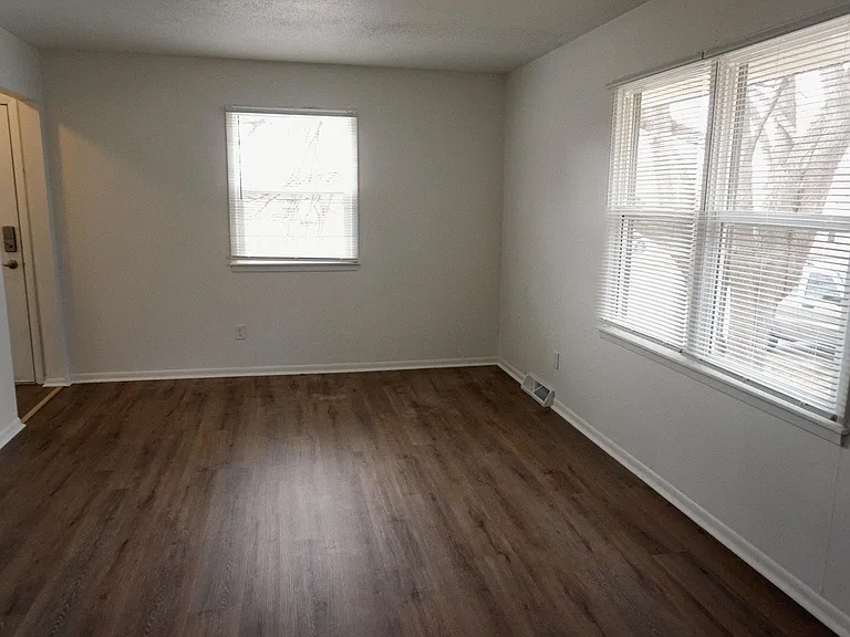 Living room with new flooring, freshly painted walls and trim