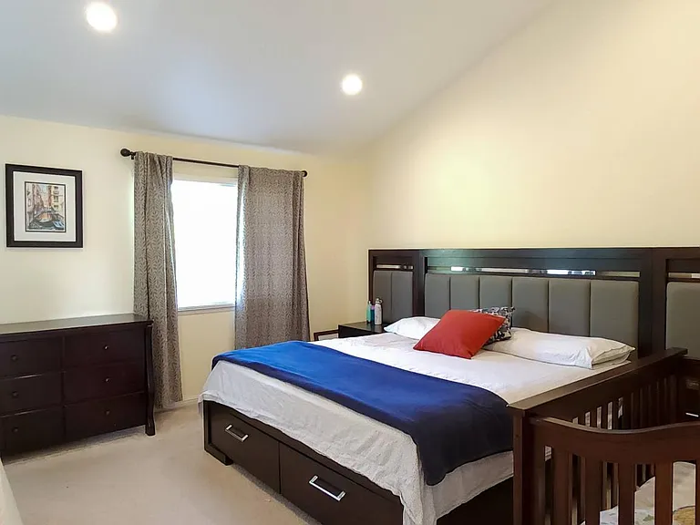 Master bedroom with carpets before which have now been replaced with wooden flooring