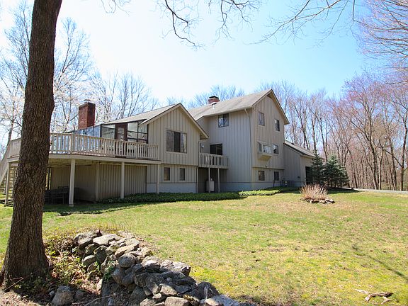 Rear view of the home with it's huge, level and private yard.