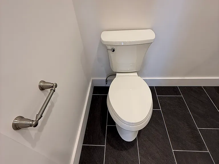 KOHLER BRAND TOILET AND SLATE FLOORING