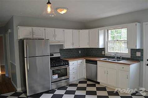 Updated kitchen with brand new stainless steel appliances, new counter tops and new recycled glass tile back splash.