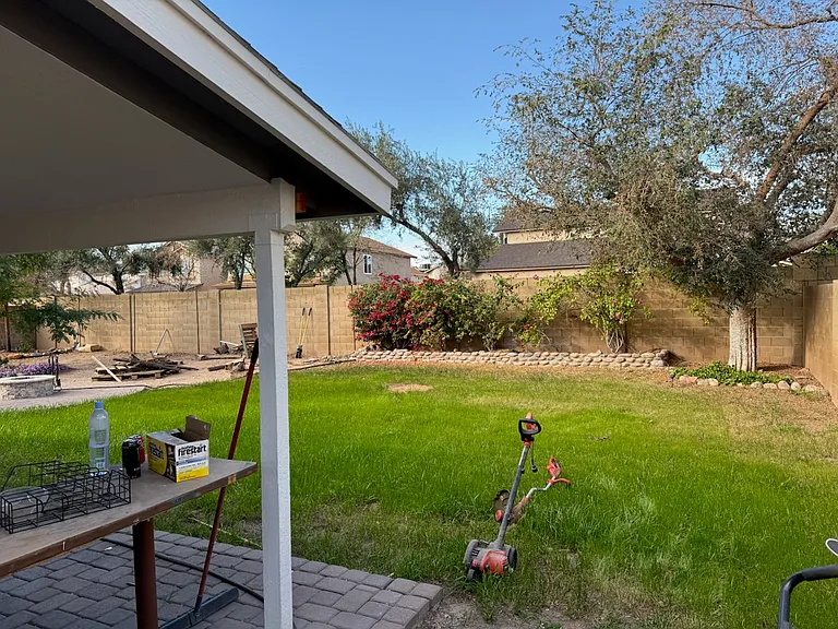BEFORE PIC of small posts on back patio and water grass yard with no irrigation