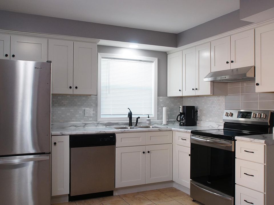 Newly Remodeled Kitchen with many new appliances, new cabinets with soft close doors and drawers, tile back splash, stainless steel sink with garbage disposal, range hood that vents outdoors and oil rubbed bronzed finished faucet.