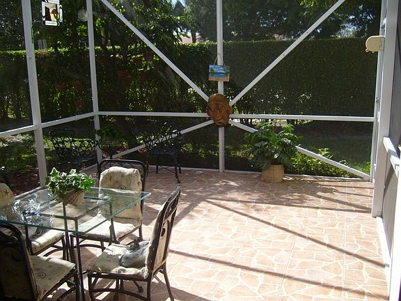 Tiled 1/2 covered screened patio