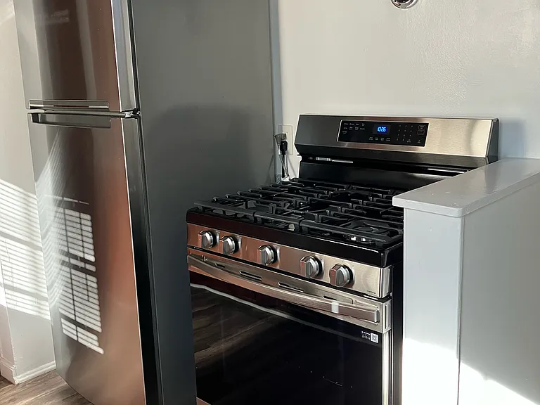 STAINLESS STEEL SAMSUNG 30 IN 5 BURNER SMART GAS RANGE and STAINLESS STEEL WHIRLPOOL 18 CU FT TOP FREEZER REFRIGERATOR