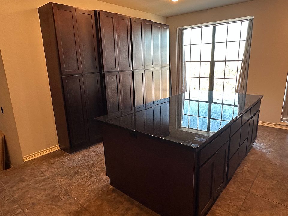 Loads of storage in this new bank of wall cabinetry, epoxy countertops, and floor to ceiling windows with blackout curtains in kitchen.