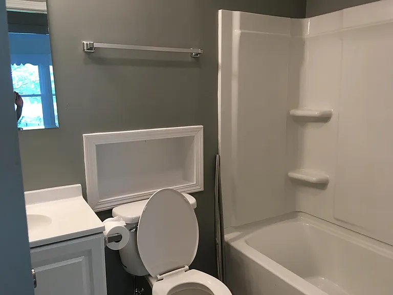 Bathroom with tub and shower, heater in vent fan, near bedrooms 2 and 3 and office/playroom.
.