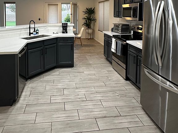 Kitchen: fridge, dishwasher, pantry, air fryer, and stove.