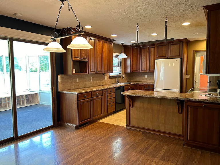 kitchen with breakfast bar and rack for pots and pans