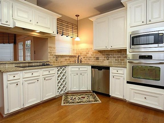 Gorgeous updated kitchen with wood floors, new stainless appliances, new granite counter tops, stone backslash.