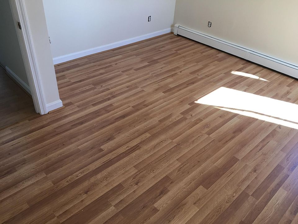 Renovated bedroom with new flooring, paint and shades.