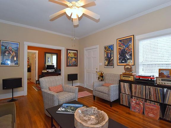 View of the front door that opens to the living room. The home has lots of window that brings in the light. Most rooms are 9 foot ceilings with crown molding.  Hardwood floors throughout except tile in the kitchen.