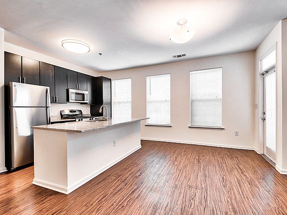 Open-Concept Floor Plans with luxury black walnut vinyl flooring