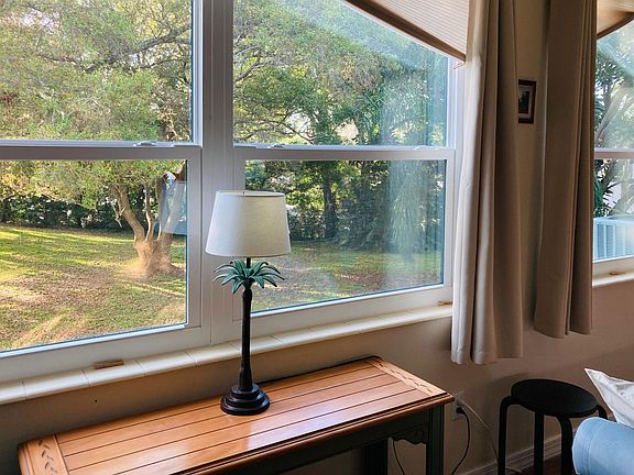 Back windows along entire condo overlooking trees and sky. A nice calming view.