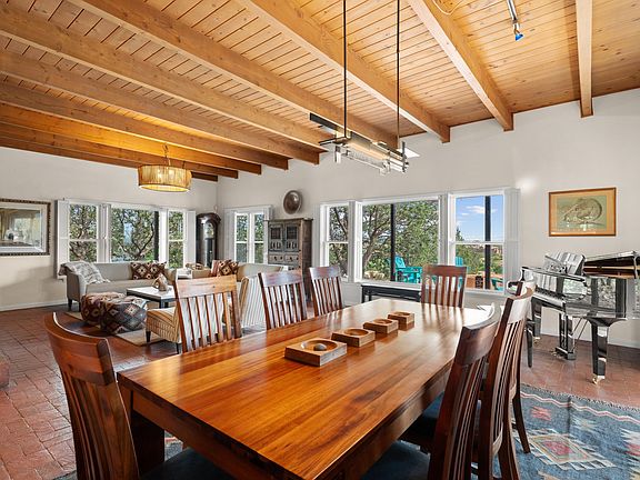 Dining Table (sits 8 comfortably). Baby grand piano in background.