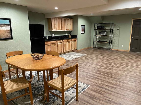 Recently renovated kitchenette area which includes full fridge, microwave, air fryer, and electric hobs for cooking. Plenty of storage with utility shelves.
