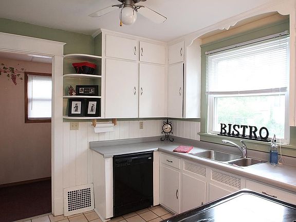 Kitchen features new dishwasher plus stove and refrigerator.