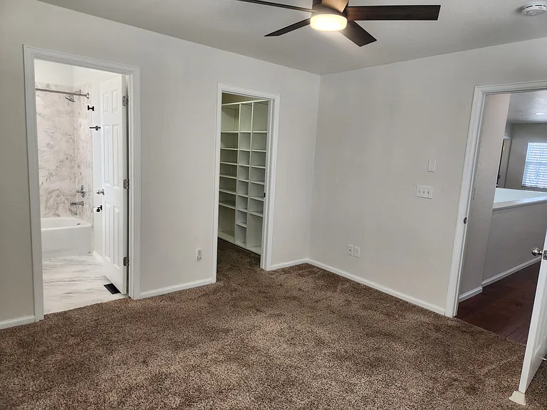 Primary bedroom w/ large closet and attached bath