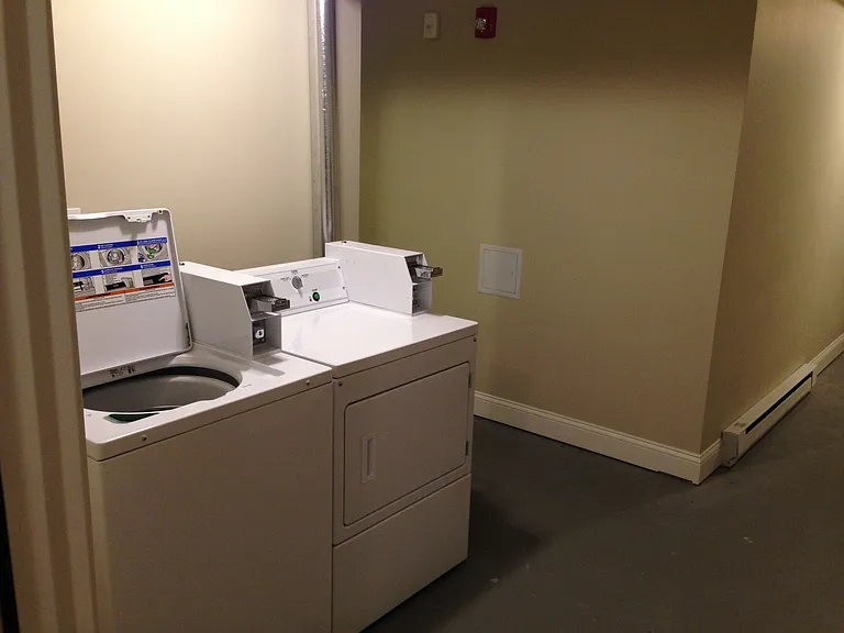 Coin-operated laundry area features 2 washers and 2 dryers