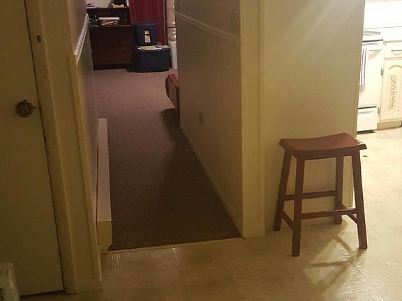 Door leading down to garage with storage