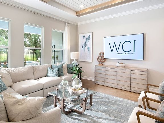 Several wide windows brighten this central family room, with quick access to the kitchen and outdoor