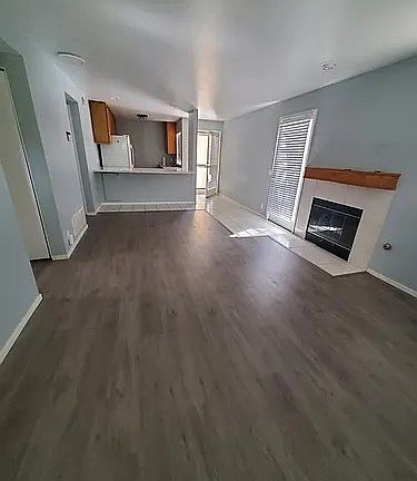 Livingroom from front door entrance, showing back door & side door patio entrances