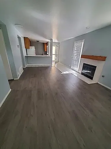 Livingroom from front door entrance, showing back door & side door patio entrances