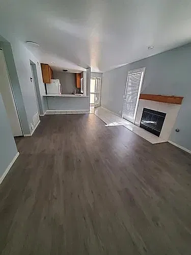 Livingroom from front door entrance, showing back door & side door patio entrances
