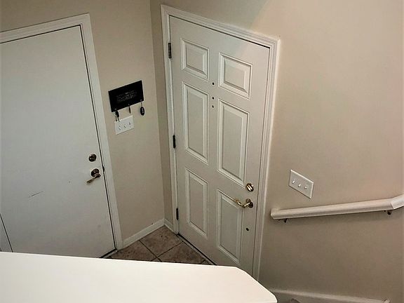 Foyer with entry door and Door to Garage