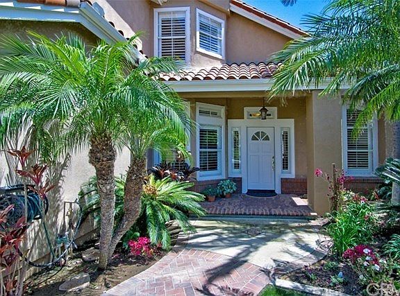 Meandering pathway through colorful planters lead to your new home!