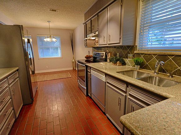 Kitchen With Solid Surface Counter Tops and Stainless Steel