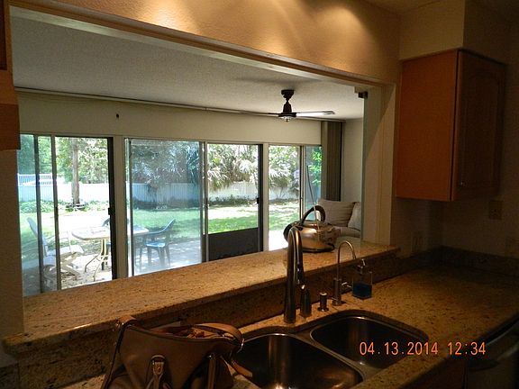 The kitchen overlooks the back room, the New deck and the large backyard.