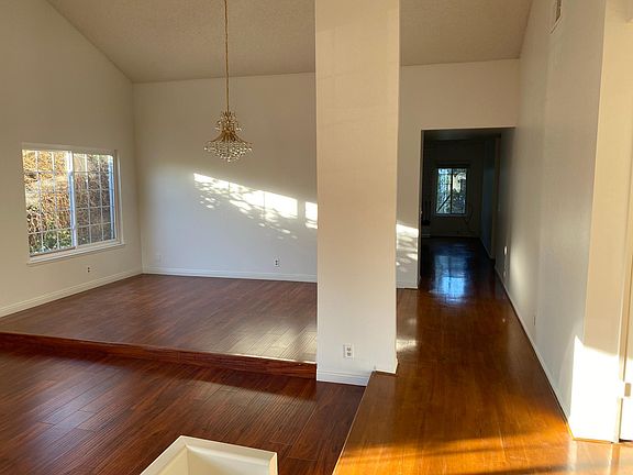 Living room with chandelier and high vaulted ceilings