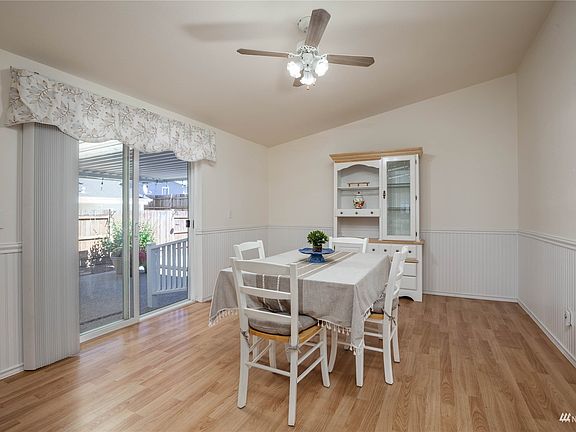 Large breakfast nook off the kitchen has slider to covered patio>