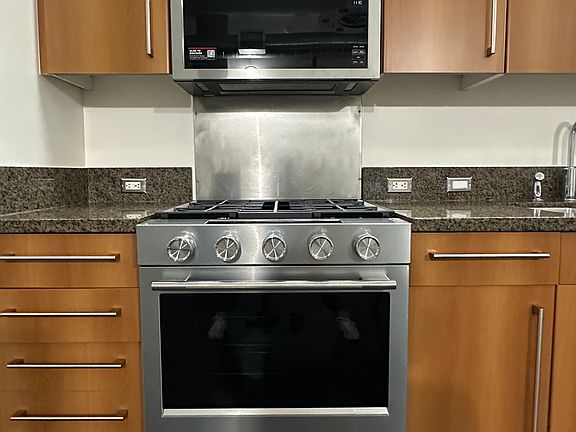 New KitchenAid microwave and gas range and oven.
