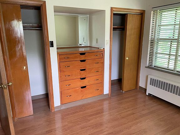 bedroom #1 with dresser and closets.