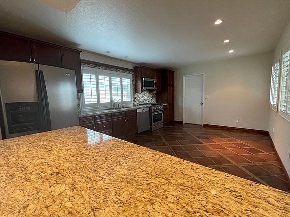 Spacious kitchen with stainless steel, recessed lighting and access to garage/laundry
