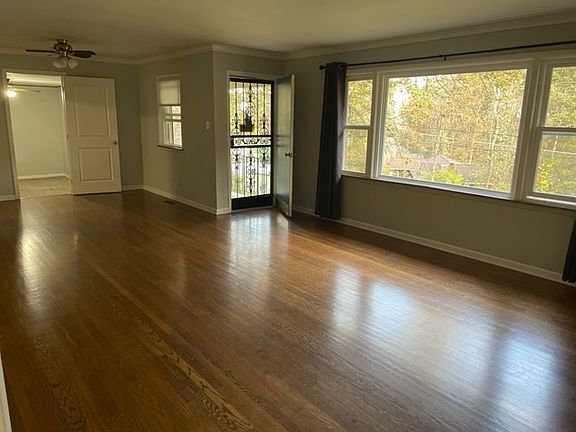 Living room, Dining room looking towards front. Hardwood floors throughout.