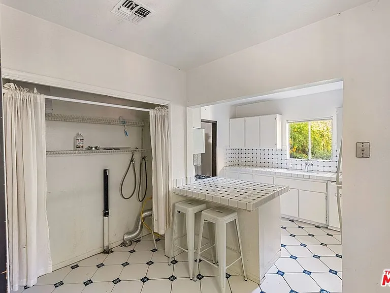 Kitchen showing center island and washer dryer hookups