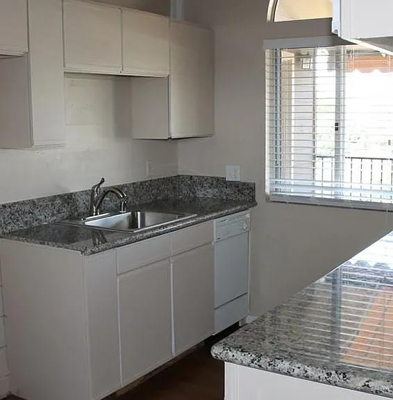 Upstairs bar area w/ refrigerator, dishwasher, sink, wine cooler