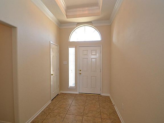 Elegant entry with tile floors, raised tiered ceilings and double crown molding.