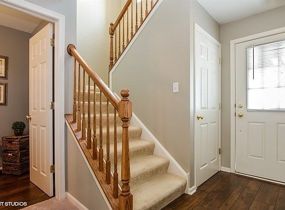 Enter to foyer with powder room adjacent and stairs to 2nd floor