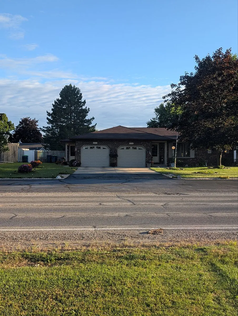 The landscaped duplex view across the street in this upscale and quiet safe north west Saginaw Township offers the widest entrance and additional paved parking on Weiss St for a residence - 6240 Weiss St