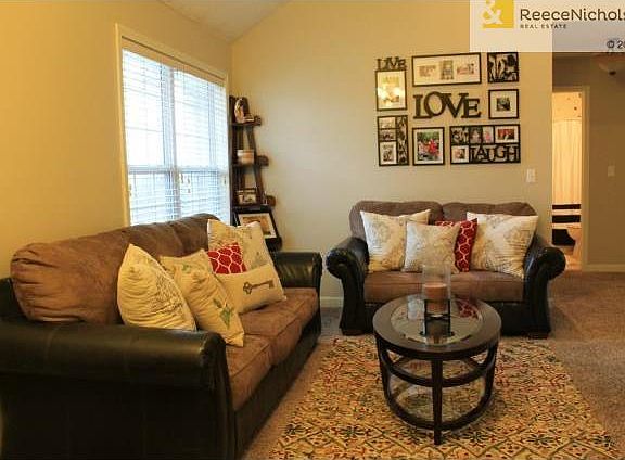 LIVING ROOM WITH NEUTURAL DECOR AND NEWER CARPET
