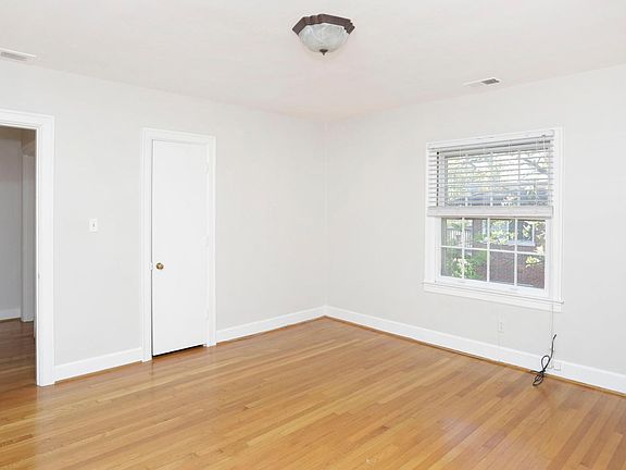 This is the bedroom. It's located in the front of the building. It has two windows: one facing the front of the building and the other facing the side of the building. The closed door is the closet (there are two more closets in the apartment)