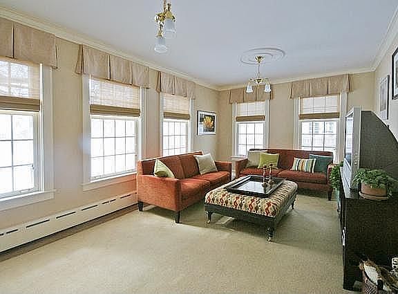 Large sunny family room that looks out a extra large backyard