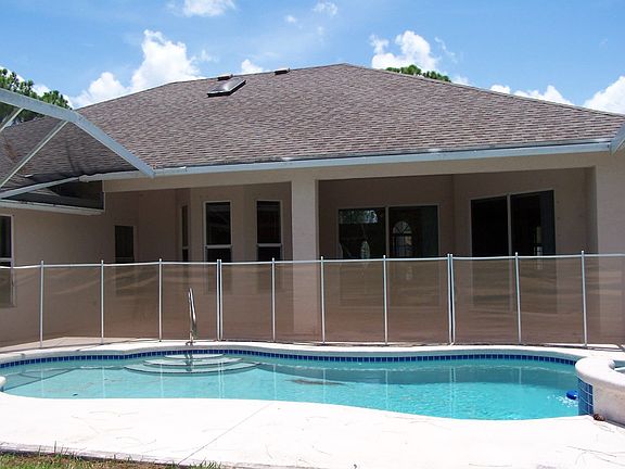 POOL AREA, SCREEN ENCLOSURE NEEDS TO BE REPAIRED OR REMOVED, POOL/SPA COMBO.